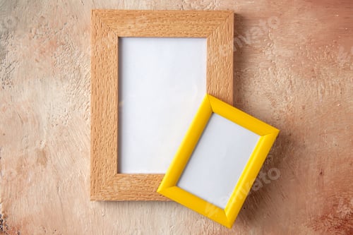 Preview: Close up view of small and big colorful photo frames hanging on mix color wall with free space