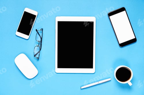 Preview: Top view, Modern workplace with tablet with smart phone placed on a pastel blue background