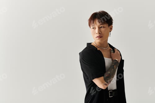 Preview: Stylish Asian man in a minimalist setting showcasing modern fashion and confidence