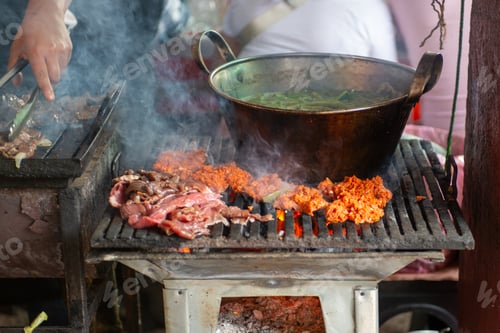 Preview: Outdoor street food preparation with grilled meat and nopal cactus