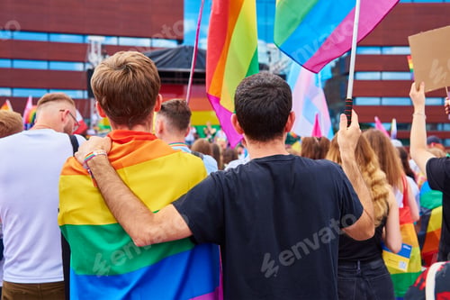Preview: Two male friends with rainbow flags on pride demonstration
