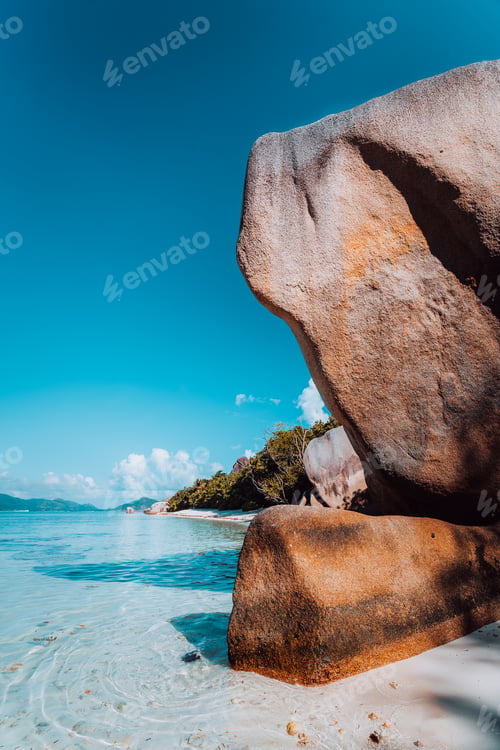 Preview: Huge beautifully shaped bizarre granite boulders in evening light at famous Anse Source d'Argent