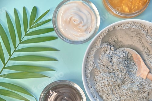 Preview: spa massage clay powder, face masks, bath salt, towel, shea butter on blue table background.