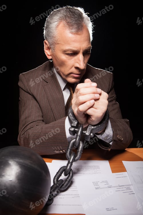 Preview: Chained businessman.