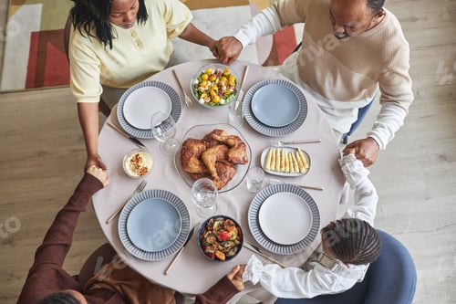 Preview: African family praying before dinner