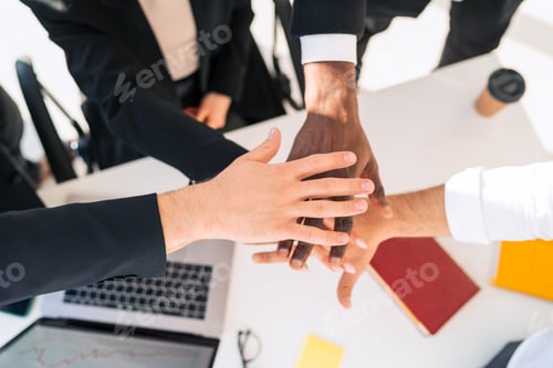 Preview: Multiracial business people staking hand together