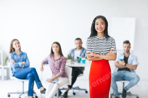 Preview: Confident asian business leader with her team on background