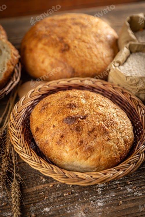Preview: Whole fresh bread in wicker basket