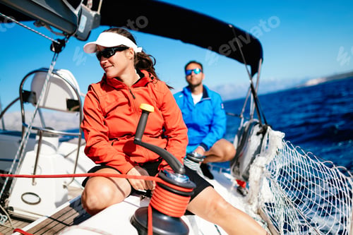 Preview: Attractive strong woman sailing with her boat