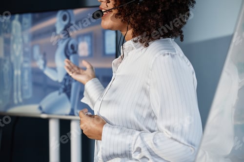 Preview: Black Female Speaking into Microphone Presenting at Business Forum