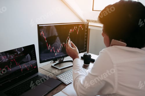 Preview: Agent trader man talking at telephone and checking business stock data on computer in office room.
