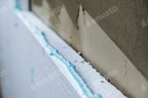 Preview: Installation of styrofoam insulation sheets on house facade wall for thermal protection.