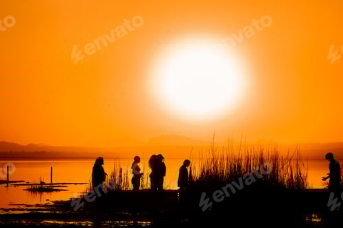 Preview: People at the orange sunset by the lake