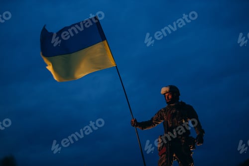 Preview: Ukrainian defender wath a national flag in the evening