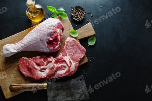 Preview: Raw meat on board on dark