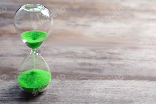 Preview: Hourglass with flowing sand on table. Time management