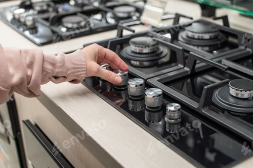 Preview: The buyer's hand checks the gas stove in the store