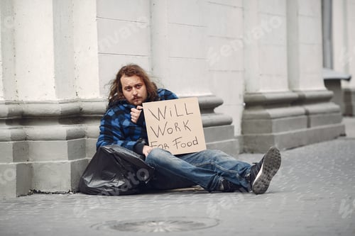 Preview: Homeless man in a durty clothes autumn city