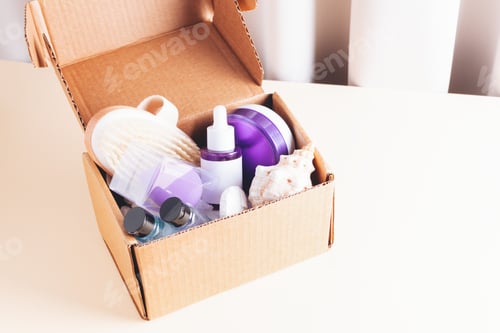 Preview: Sample box of different skincare products on beige background.
