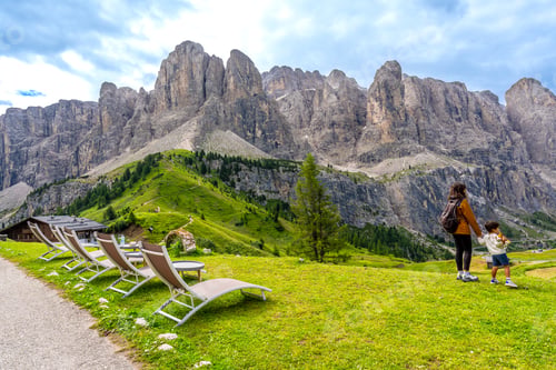 Preview: Tourists admiring the majestic dolomites at gardena pass in summer, italy