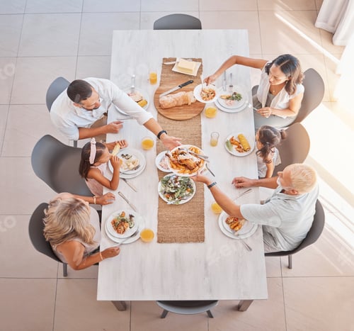 Preview: Family, lunch and food at the table with big family bonding, sharing and eating together at the din