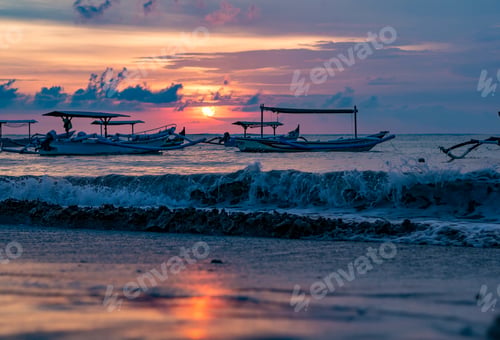 Preview: traditional Balinese ships Jukung close on Sanur beach at sunrise