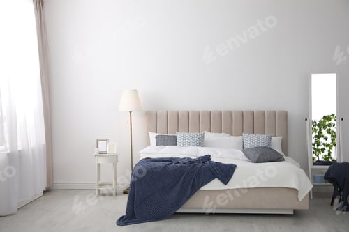 Preview: Comfortable bed with pillows in room. Stylish interior design