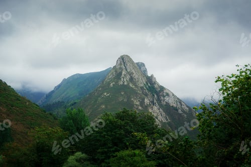 Preview: Stunning landscape of Asturias, Spain with green mountains against a cloudy sky