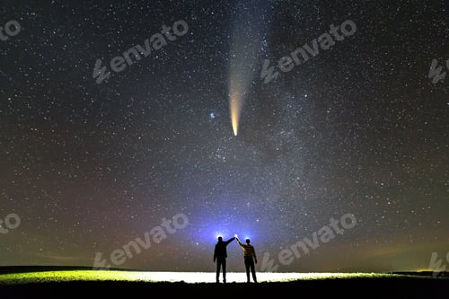 Preview: Small silhouettes of two scientists with flashlight on heads pointing bright beam of light