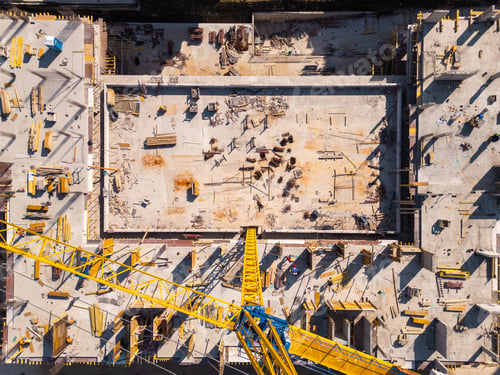 Preview: Construction site showcases vibrant materials and equipment under bright sunlight in an urban area.