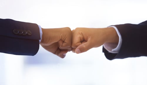 Preview: Shot of two unrecognizable businessmen bumping fists against a white background