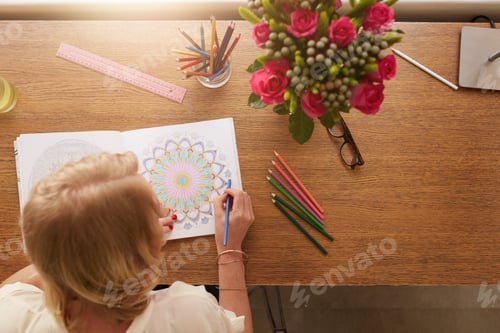 Preview: Woman drawing in adult coloring book