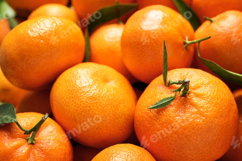 Preview: Fresh ripe tangerines with leaves as background, above view. Citrus fruit