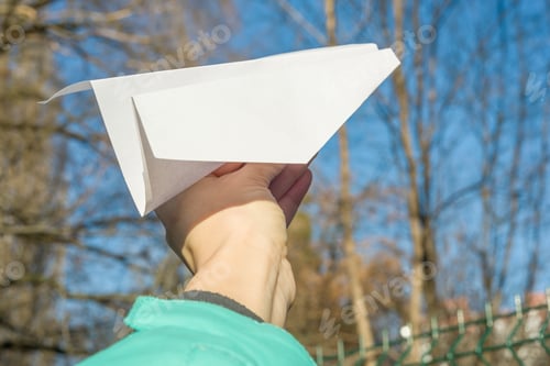 Preview: Abstract paper plane, in hand, blue sky, sun spring background.