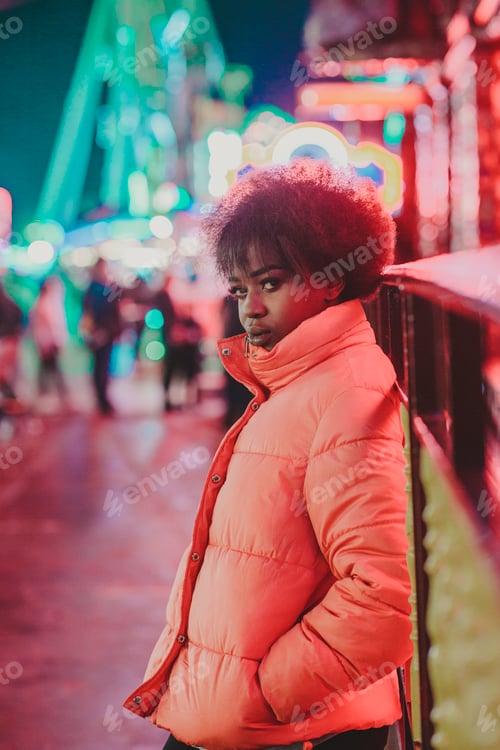 Preview: Black female standing near attraction in amusement park