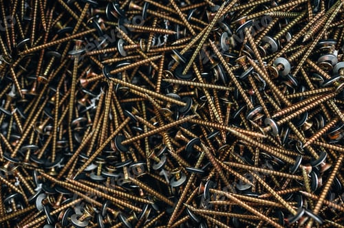Preview: Many of the golden colored screws laying down, top view of quality products