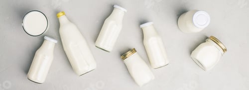 Preview: Various bottles of milk on grey concrete background