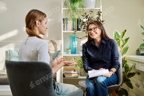 Preview: Female psychologist having therapy session with young woman