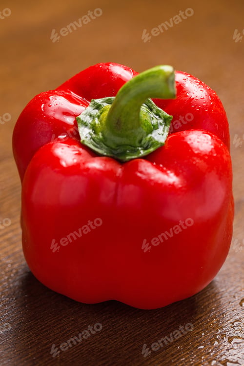 Preview: Fresh and wet red paprika over wooden surface