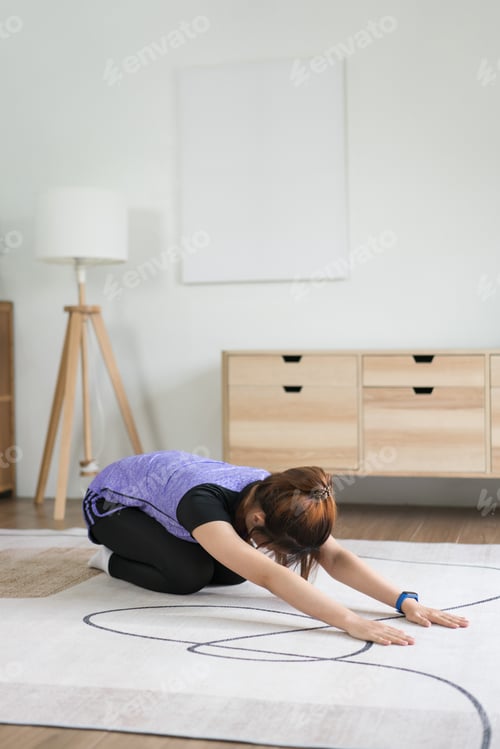 Preview: Woman in Child's Pose on Rug at Home