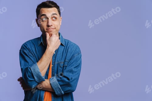 Preview: Young brunette white man thinking and looking aside