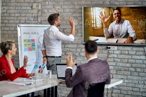 Preview: Happy Businessman Having A Video Conference And Greeting With His Team Who Is Working In The Office.