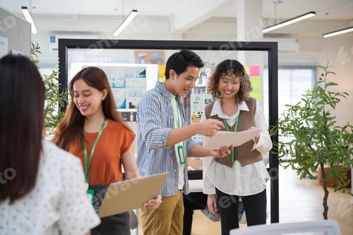 Preview: Group of young Asian business people team meeting in modern office working