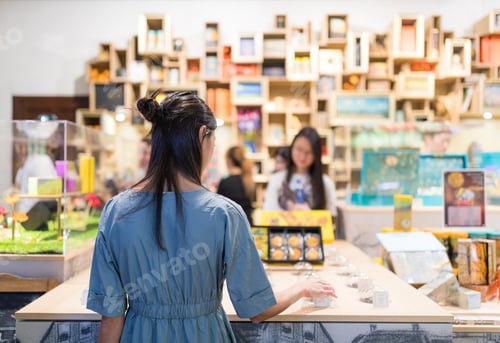 Preview: Woman picking product inside shop