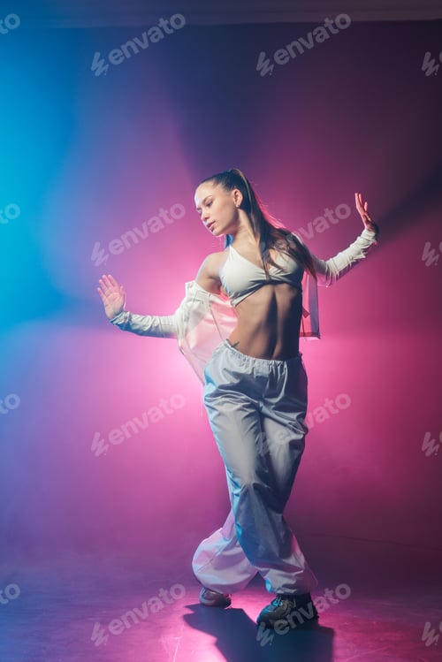 Preview: Neon jazz funk hip hop dancer posing in blue and pink studio lighting