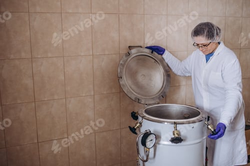 Preview: medicine science factory staff worker products sterilize process in autoclave tank in lab.