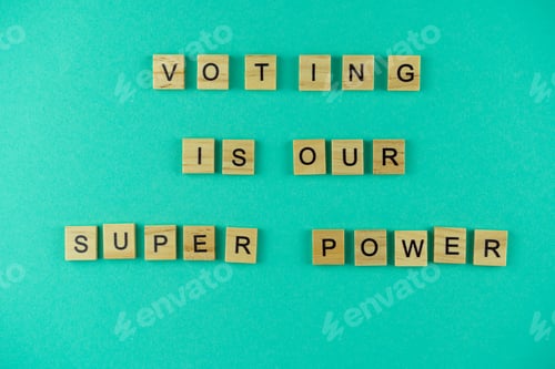 Preview: Words voting is our superpower. The phrase is laid out in wooden letters. Top view. Motivation. Blue