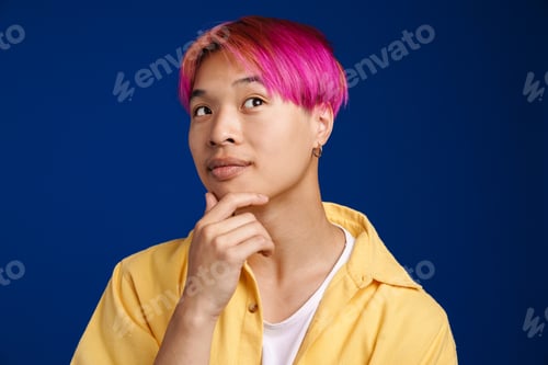 Preview: Asian boy with pink hair posing and looking aside