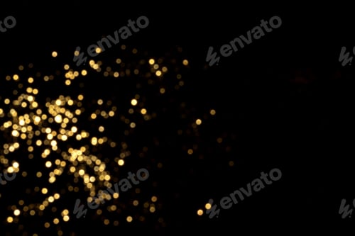 Preview: Golden blurred bokeh lights on black background