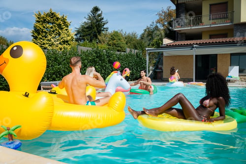 Preview: Friends having fun in a swimming pool